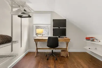 This cozy little office nook is the perfect spot for guests who need to get some work done during their stay. Equipped with a desk, chair, and lamp, it provides a comfortable workspace.