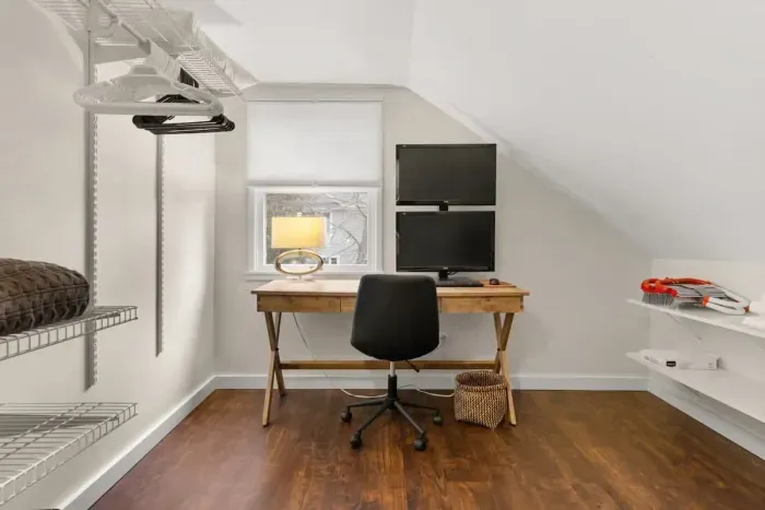 This cozy little office nook is the perfect spot for guests who need to get some work done during their stay. Equipped with a desk, chair, and lamp, it provides a comfortable workspace.