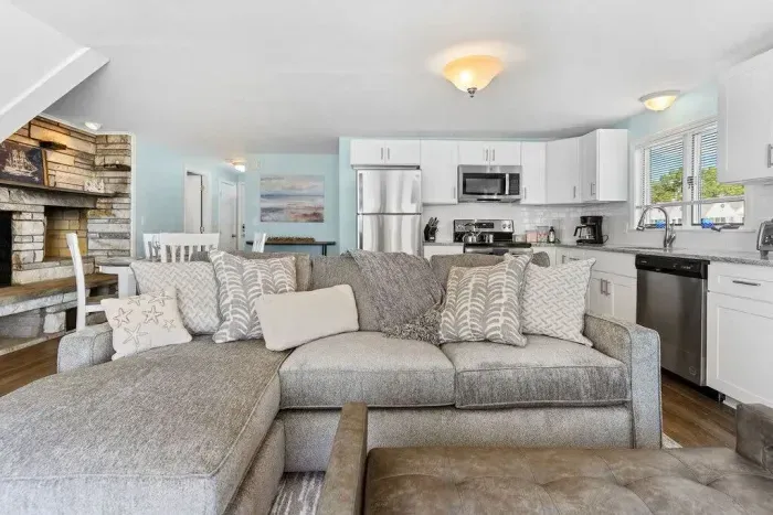 Living room with sleeper sofa, 50" smart TV, high-efficiency mini-split for AC/heat, and stunning views of the ocean.