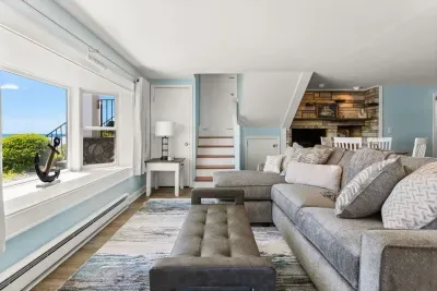 Living room with sleeper sofa, 50" smart TV, high-efficiency mini-split for AC/heat, and stunning views of the ocean.