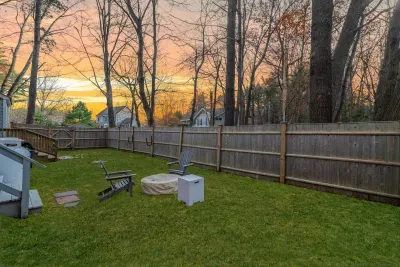 The fenced-in backyard! Perfect for your furry friend! Also featuring a gas fire-pit.