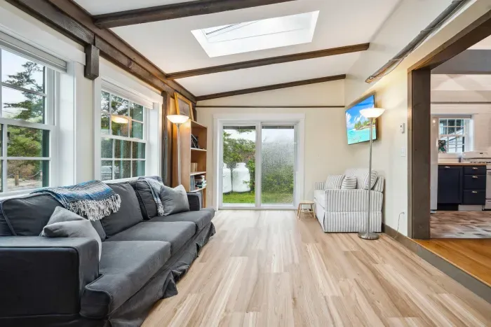 Living room with sectional couch, Smart TV, and gas fireplace