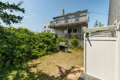 The outdoor shower is located on the backside of the house. There is direct access to the house via the slider here.
