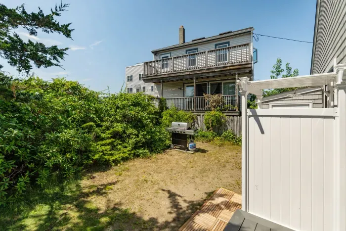 The outdoor shower is located on the backside of the house. There is direct access to the house via the slider here.