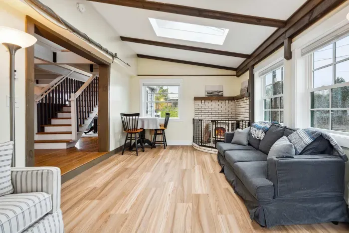 Living room with sectional couch, and Smart TV. Please note - the gas fireplace is inoperable.