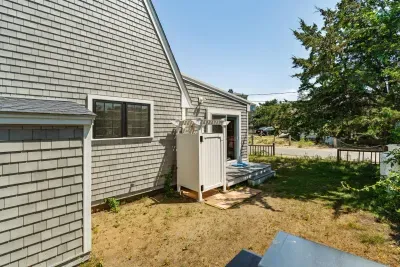 The outdoor shower is located on the backside of the house. There is direct access to the house via the slider here.