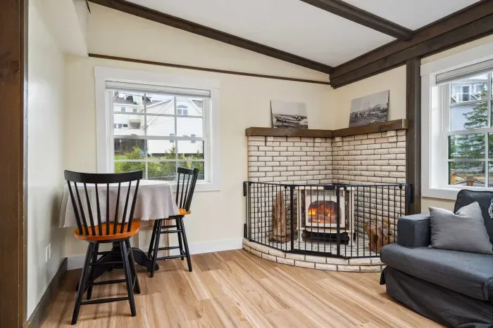 Living room with sectional couch, and Smart TV. Please note the fireplace is inoperable