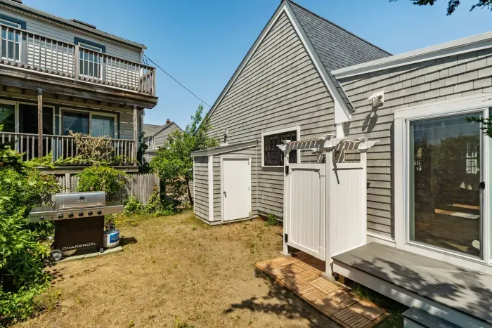The outdoor shower is located on the backside of the house. There is direct access to the house via the slider here.