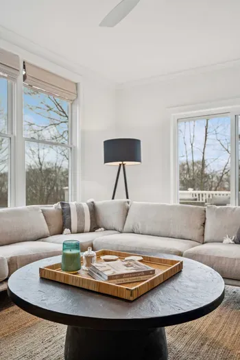 Living area with plenty of natural light, an ocean breeze, and access to the back deck.