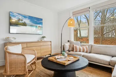 Living area with plenty of natural light, an ocean breeze, and access to the back deck.