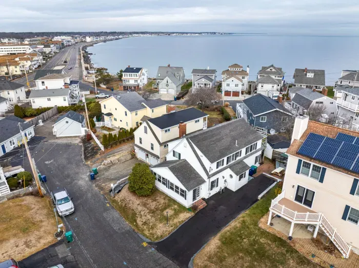The home from the street, featuring a new driveway and hardscaping! Parking for 3 cars comfortably