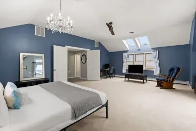 Second level master bedroom with king bed, double doors leading out to private deck & roof deck with views of the Atlantic Ocean
