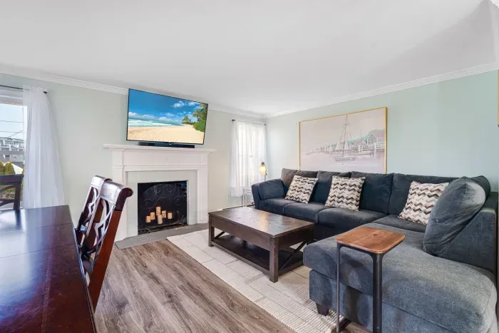 Family room with large sectional and Smart TV! Please note - fireplace is inoperable