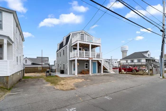 Exterior of property. This unit is located on the ground level, and comes with 2 off-street parking spots (parked side-by-side on the left-hand side of the driveway)