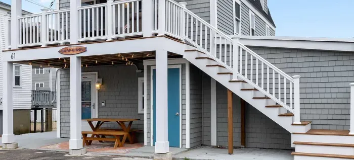 Exterior of property. This unit is located on the ground level, and comes with 2 off-street parking spots (parked side-by-side on the left-hand side of the driveway)