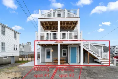 Exterior of property. This unit is located on the ground level, and comes with 2 off-street parking spots (parked side-by-side on the left-hand side of the driveway)