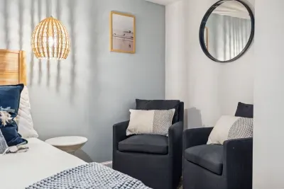 Primary bedroom with seating area and Queen bedroom