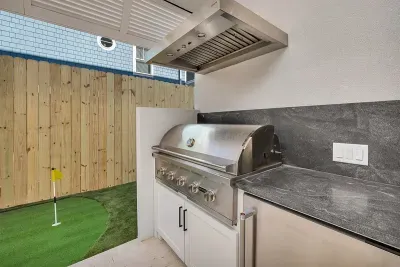 heatable salt water pool with hot tub, natural gas barbecue grill, dining area, 75' TV, Sonos Sound System