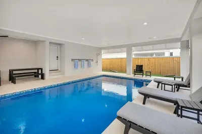 heatable salt water pool with hot tub, natural gas barbecue grill, dining area, 75' TV, Sonos Sound System