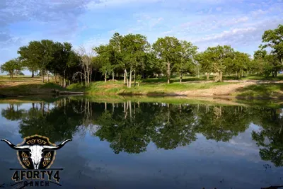 A view of the pond and game center that features a pickleball court