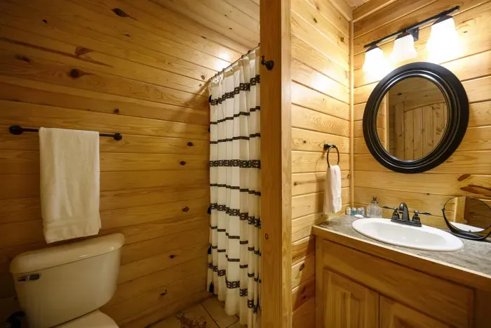 Guest bathroom off the main hall with a shower and vanity