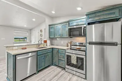 Kitchen with stove/oven, microwave, dishwasher, and fridge