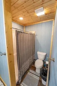 This room is in the detached living quarters.  The detached living quarters includes two bedrooms and a bathroom.  This is the shower and toilet area.  The bathroom is situated between the two bedrooms.