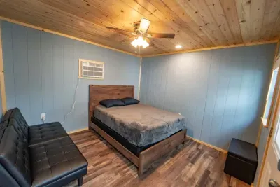 This room is in the detached living quarters.  It ideal for privacy.  The detached living quarters includes two bedrooms and a bathroom.  This room includes queen size bed and futon.