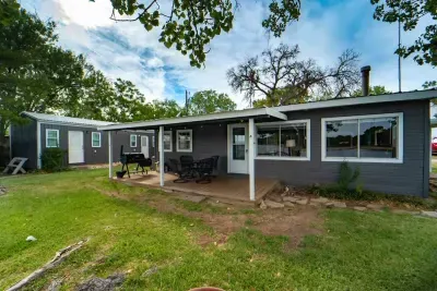 There is a small green space next to the water.  There are two living spaces.  The house that includes 3 bedrooms, a bath, kitchen and living room. The detached cabin has two bedrooms and a bathroom.