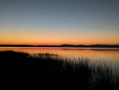 This portrait of serenity captures a breathtaking sunset on the north shore of our property, reflecting the peaceful grandeur of Possum Kingdom Lake.