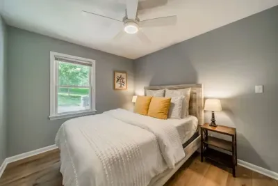 Bedroom towards the front of the home with Queen-sized bed and adjacent bathroom