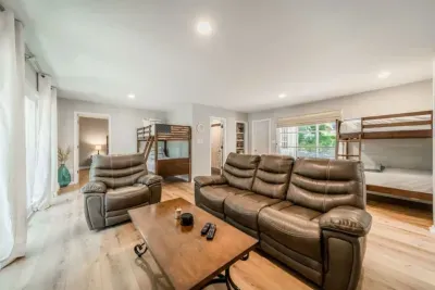 Common area with huge LCD TV and 4 twin-sized bunk beds