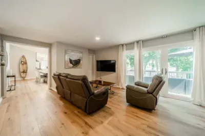Common area with huge LCD TV and 4 twin-sized bunk beds