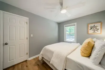 Bedroom towards the front of the home with Queen-sized bed and adjacent bathroom