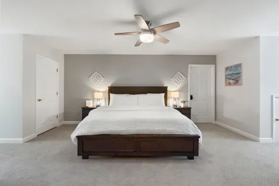 This second-floor bedroom offers a spacious king bed, a TV for relaxing, and a cozy office nook… perfect for work or winding down.