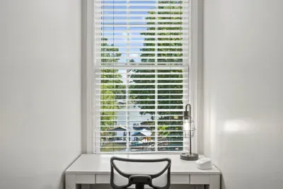 This second-floor bedroom offers a spacious king bed, a TV for relaxing, and a cozy office nook… perfect for work or winding down.