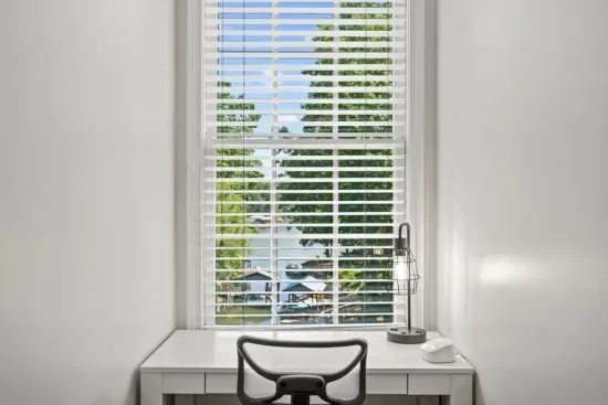 This second-floor bedroom offers a spacious king bed, a TV for relaxing, and a cozy office nook… perfect for work or winding down.