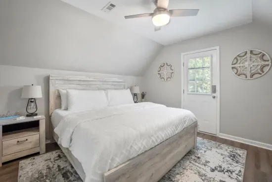 The king bedroom in the apartment space features its own private deck, offering a peaceful retreat and the perfect spot to relax outdoors.