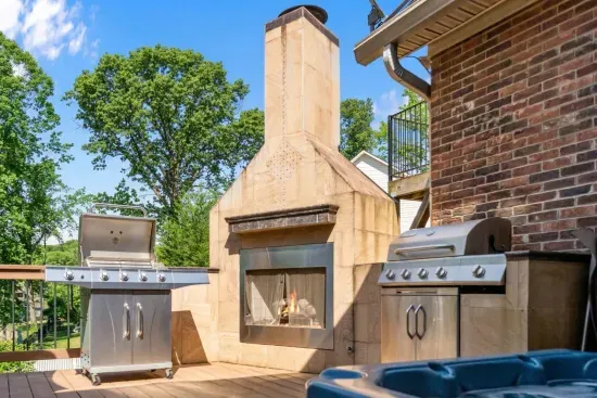 Our expansive deck boasts a BBQ grill, outdoor fireplace, and hot tub, perfect for enjoying the outdoors in comfort and style all season long.