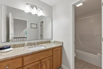 This shared bathroom with a shower serves both second-floor bedrooms, offering convenience and comfort for everyone.
