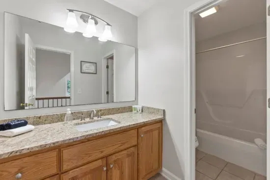 This shared bathroom with a shower serves both second-floor bedrooms, offering convenience and comfort for everyone.