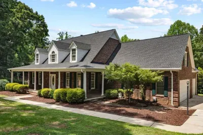 The front of the home features charming curb appeal with a welcoming entrance and spacious driveway.