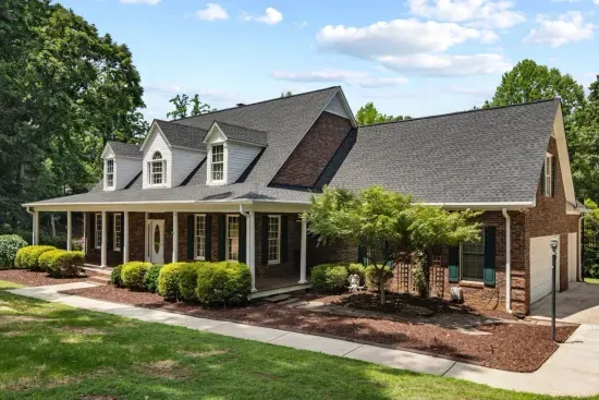 The front of the home features charming curb appeal with a welcoming entrance and spacious driveway.