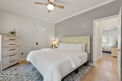 The first-floor bedroom with a king bed is perfect for those who prefer to skip the stairs, offering comfort and easy access to the rest of the home.