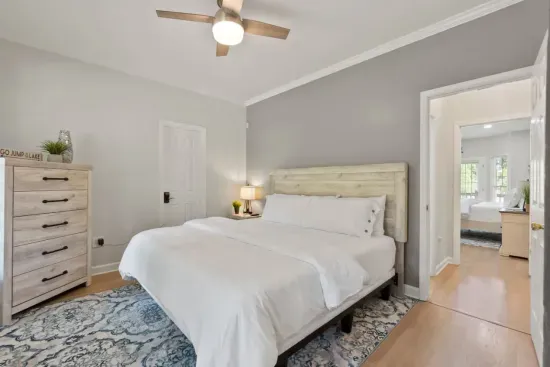 The first-floor bedroom with a king bed is perfect for those who prefer to skip the stairs, offering comfort and easy access to the rest of the home.