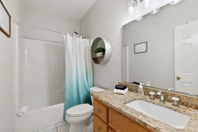 A convenient bathroom with a shower serves the first-floor bedroom and is easily accessible from the living room for added comfort and ease.