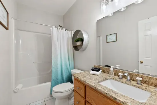 A convenient bathroom with a shower serves the first-floor bedroom and is easily accessible from the living room for added comfort and ease.