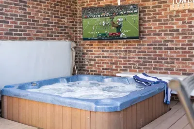 Soak, relax, and unwind in our built-in hot tub, complete with your favorite tunes or a show on the outdoor TV… ultimate comfort and entertainment!
