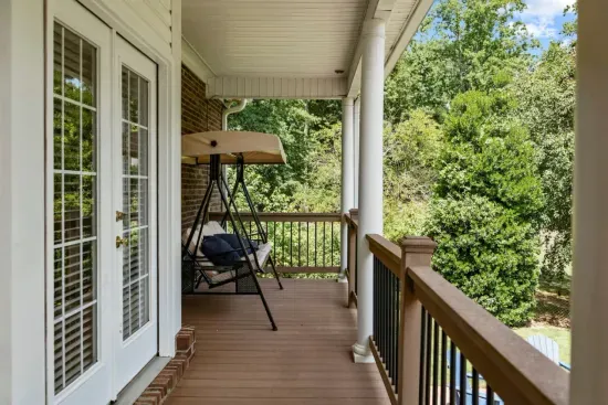 Unwind on the porch swing with serene views of the backyard and lake… the perfect spot to relax and take it all in.
