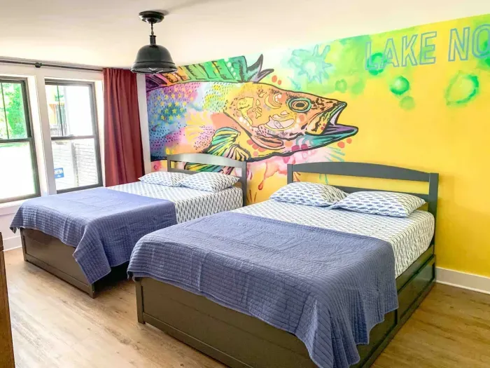 Kids will love the custom colorful mural. The room is furnished with two queen beds with two twin trundle beds.